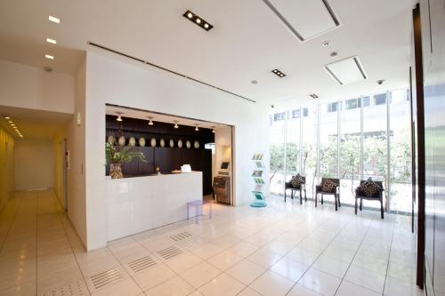 a lobby with chairs and a counter in a building at 7 Days Hotel Plus in Kochi