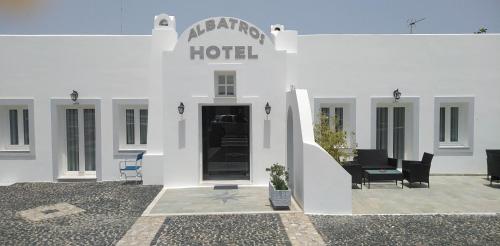 a white building with a hotel sign on it at Albatros Hotel in Karterados
