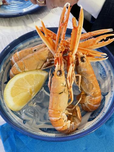 a plate of lobster and a lemon on a table at Grand Hotel Terme in Margherita di Savoia