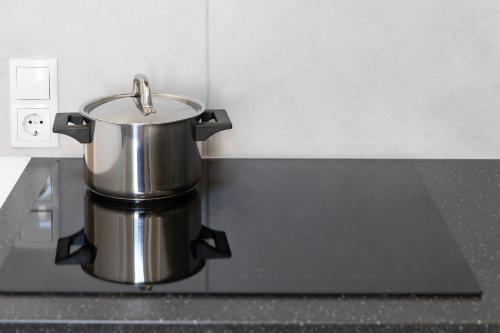 a pot sitting on a stove in a kitchen at Yeshello Apartment near Central Station in Vienna