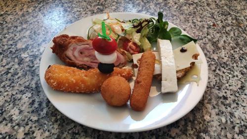 a white plate with food on a table at PENSIUNE RESTAURANT OVIDIU in Valea lui Mihai