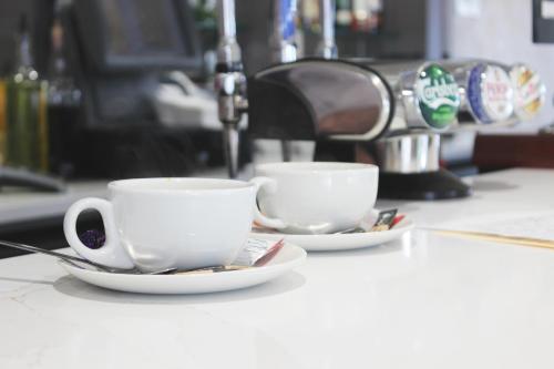 two cups of coffee sitting on a counter at Rufford Arms Hotel in Rufford
