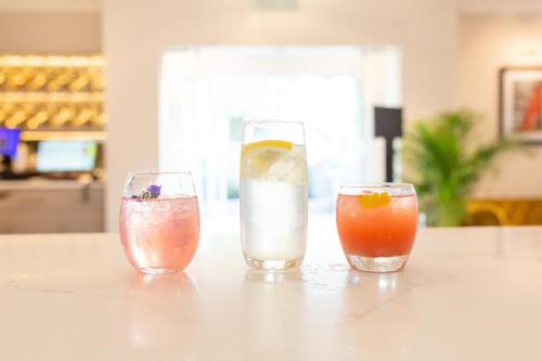 three cocktails sitting on a table in a room at Rufford Arms Hotel in Rufford