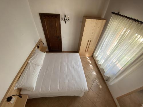 Una cama o camas en una habitación de Appartamenti Sorapiss
