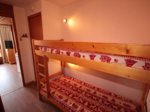 a bunk bed in a room with a rug on it at Studio Les Saisies, 1 pièce, 4 personnes - FR-1-293-146 in Les Saisies