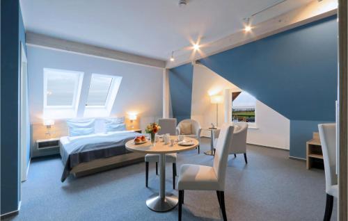 ダゲビュルにあるNice Apartment In Dagebll With Wifiのベッドルーム1室(ベッド1台、テーブル、椅子付)