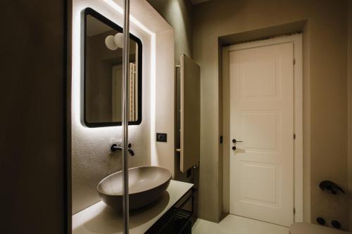 a bathroom with a sink and a mirror at Palazzo della Fontana in Matera
