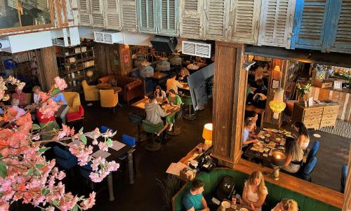 an overhead view of a restaurant with people sitting at tables at House Belfast Hotel in Belfast