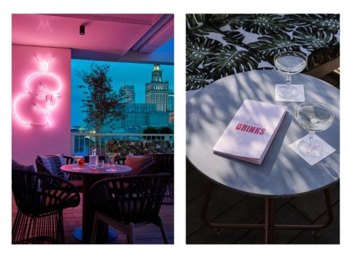 a table with a wine glass and a book on it at PURO Warszawa Centrum in Warsaw