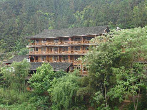 a large building in the middle of a forest at Bridge View Boutique Guesthouse 望桥楼精品民宿 in Sanjiang