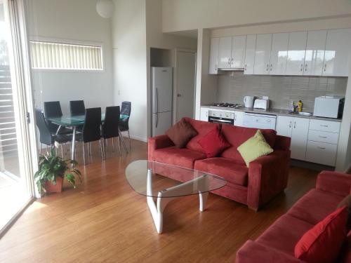 a living room filled with furniture and a couch at McKillop Geelong by Gold Star Stays in Geelong