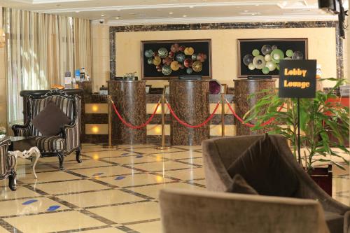 a lobby with a table and chairs in a building at Golden Tulip Addis Ababa in Addis Ababa