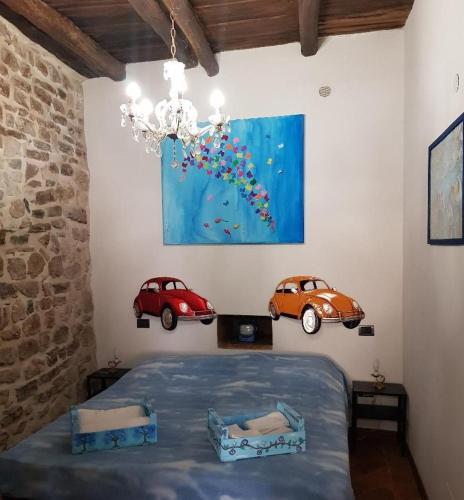 a bedroom with two cars on the wall at Non ditelo al Duca - La Cappuccina in Spoleto