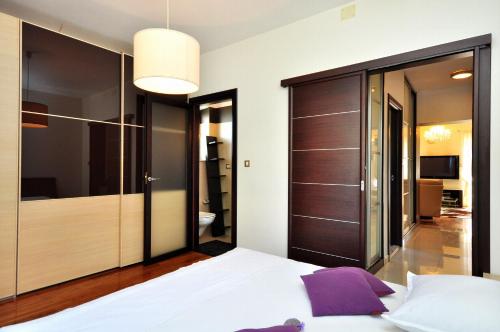 a bedroom with a bed and a large closet at Luxury Apartment Spasio in Split