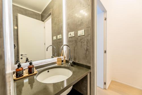 a bathroom with a sink and a mirror at My Luxury Suites - Executive in Savona