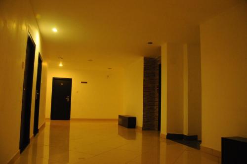 a hallway with a door and a room with yellow walls at Hotel Sri Krishna Residency in Udupi