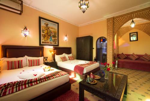 A bed or beds in a room at Riad Mabrouk