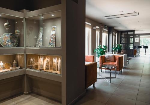 a lobby with a fireplace in a building at Modica Palace Hotel in Modica