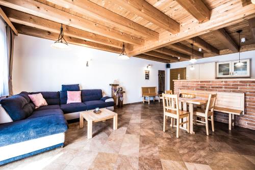 a living room with a blue couch and a table at Obermayrgut in Gallspach