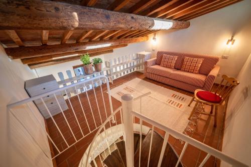 a balcony with a couch and a table at Tenuta di Poggio Cavallo in Istia dʼOmbrone