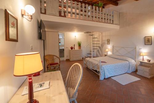 a bedroom with a bed and a table with a lamp at Tenuta di Poggio Cavallo in Istia dʼOmbrone