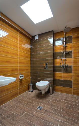 a bathroom with a toilet and a shower at Casa Di Angel in Sinemorets