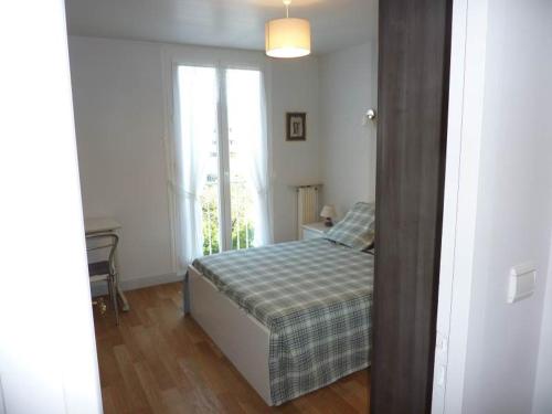 une petite chambre avec un lit et une fenêtre dans l'établissement Minerva, à Anglet