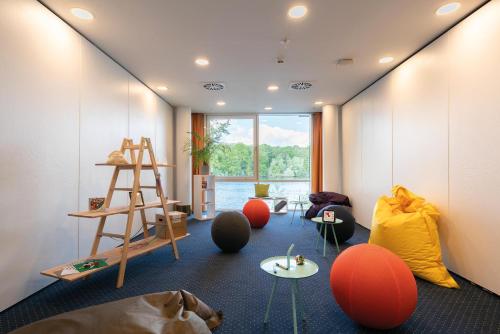a room with orange spheres and a ladder at Seminaris Hotel Potsdam Griebnitzsee in Potsdam