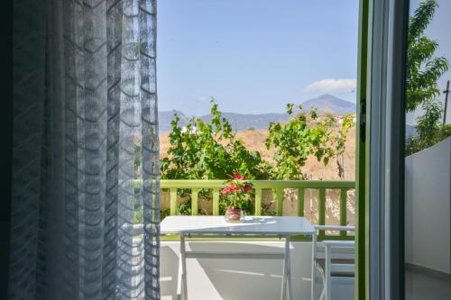 a table and chairs on a balcony with a view at Zeras Apartments in Adamas