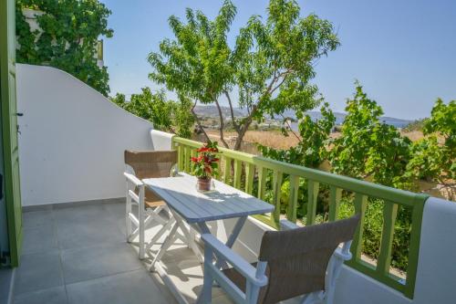 a table and chairs on the balcony of a house at Zeras Apartments in Adamas