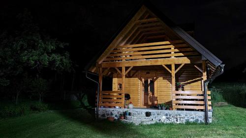 a small wooden cabin in the grass at night at Livaditsa Kremna in Kremna
