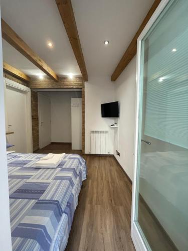 a bedroom with a bed and a sliding glass door at L'ANTICA FALCONERIA in Iesi