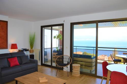 a living room with a view of the ocean at Grand T2 STANDING AJACCIO Proche centre et plages VUE PANORAMIQUE PARKING PRIVE in Ajaccio