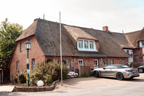 a house with a car parked in front of it at Danners Landhaus in Oevenum