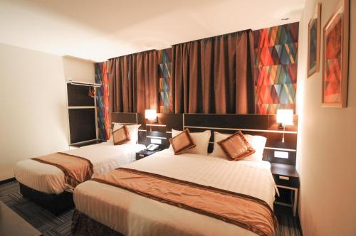 Postel nebo postele na pokoji v ubytování K Garden Hotel Parit Buntar