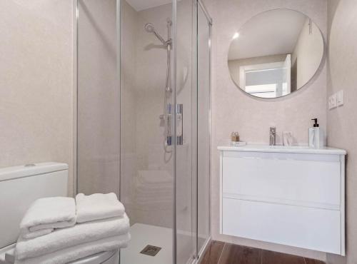 a bathroom with a shower and a toilet and a sink at Principe de Vergara I in Madrid