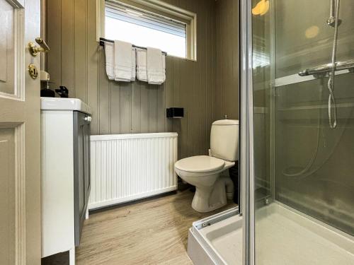 a bathroom with a toilet and a shower at Gesthus Selfoss in Selfoss