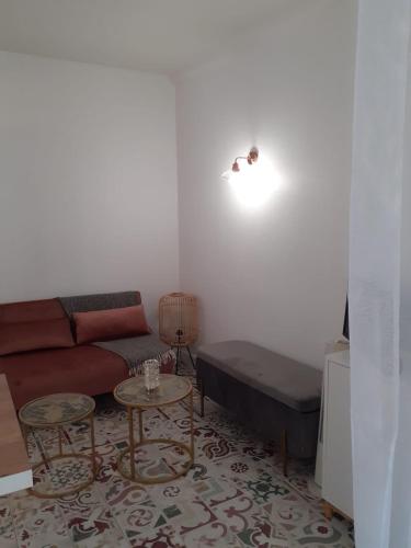 a living room with a couch and a table at Studio de l'Horloge - Studio de Charme, hyper centre Maison Jean Vilar in Avignon