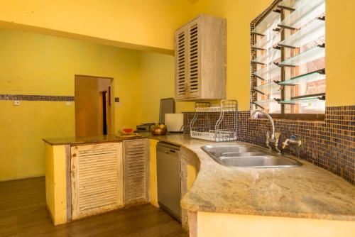 a kitchen with a sink and a counter top at Upani in Diani in Diani Beach