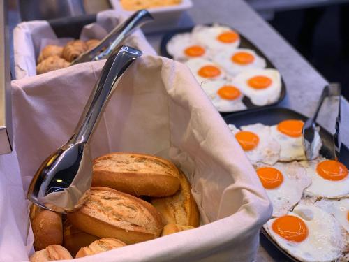 a table with two trays of eggs and bread at Smart Hotel Budapest in Budapest