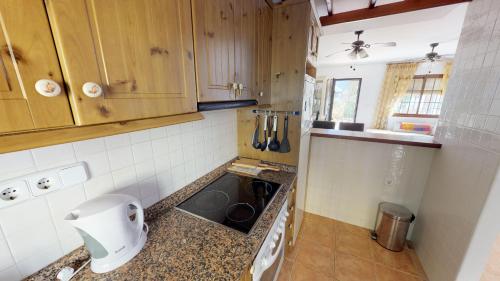 a small kitchen with a stove and a sink at Casa Rozalejo - A Murcia Holiday Rentals Property in San Javier