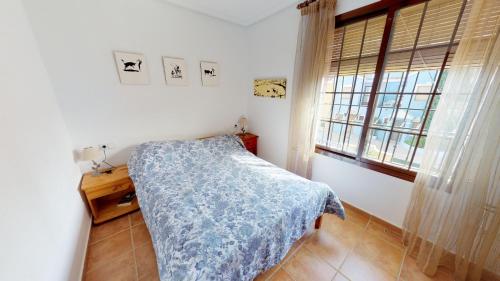 a small bedroom with a bed and a window at Casa Rozalejo - A Murcia Holiday Rentals Property in San Javier