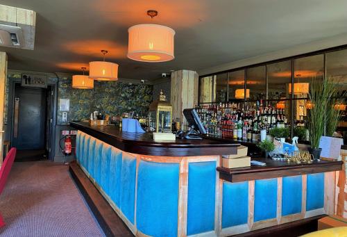 a bar in a restaurant with a blue counter at House Belfast Hotel in Belfast