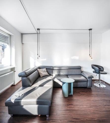 a living room with a couch and a table at BoardingWorld Heidelberg in Heidelberg