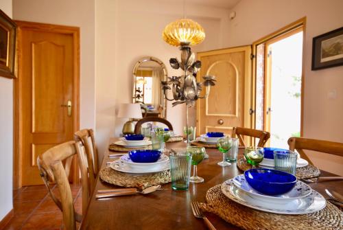 a dining room with a table with blue dishes on it at Casa El Cielo, in the heart of Old Town in Chulilla