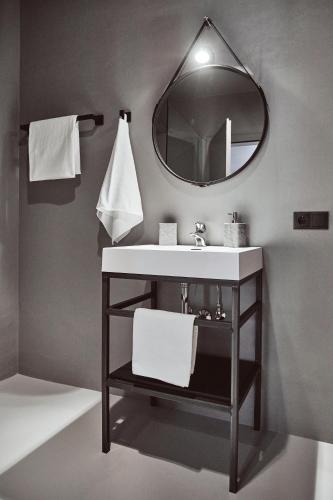 a bathroom with a sink and a mirror at Stufels 7 Design Apartment with Brixen Card in Bressanone