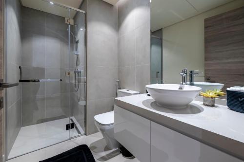 a bathroom with a sink and a toilet and a shower at Cozy Yet Stylish Unit Studio One Marina in Dubai