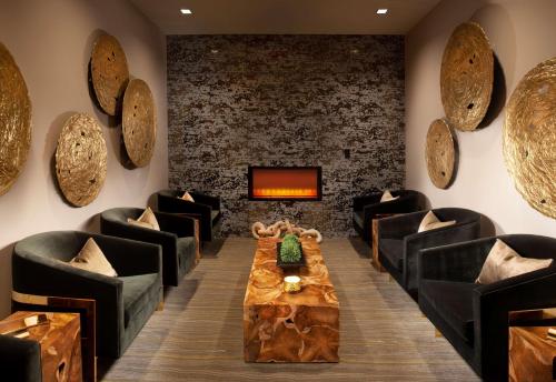 a room with chairs and a table and a tv at Grand Hyatt Nashville in Nashville
