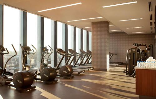a gym with a row of treadmills and machines at Grand Hyatt Nashville in Nashville