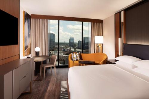a hotel room with a large bed and a large window at Grand Hyatt Nashville in Nashville